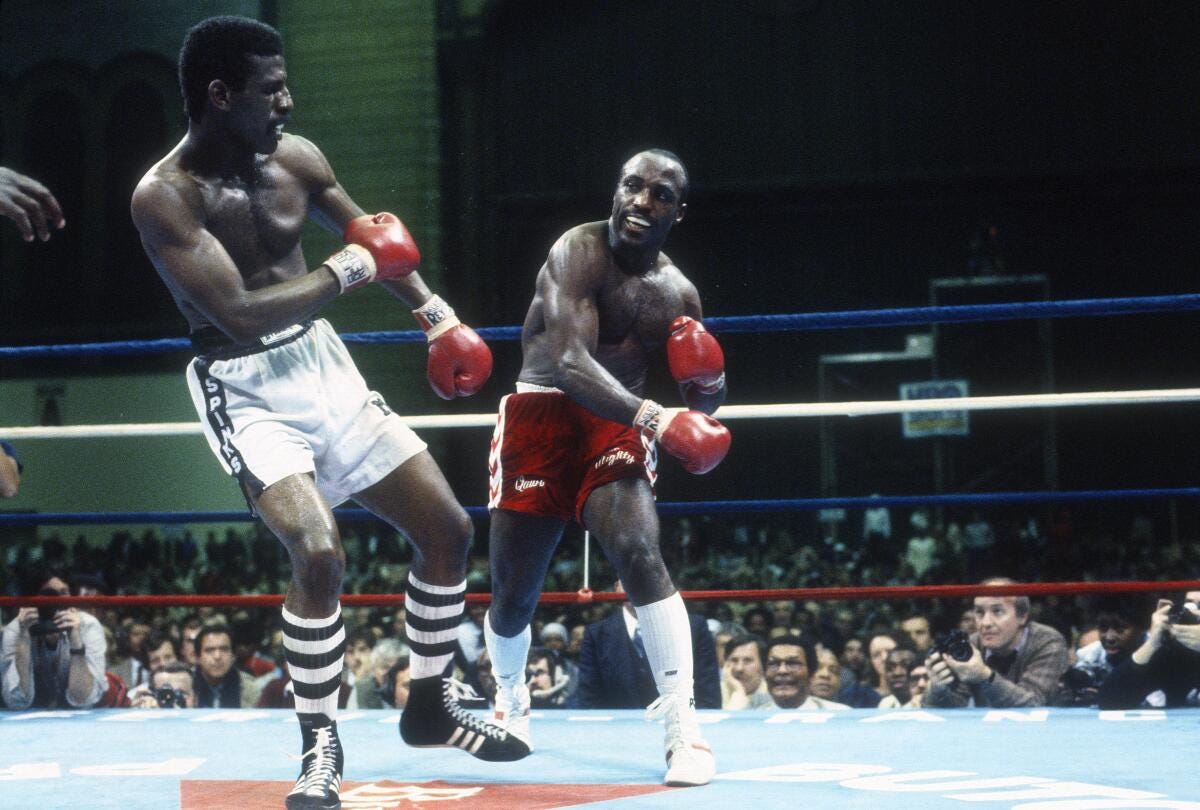 Dwight Muhammad Qawi, right, fights Michael Spinks in a light heavyweight title bout in Atlantic City, New Jersey.