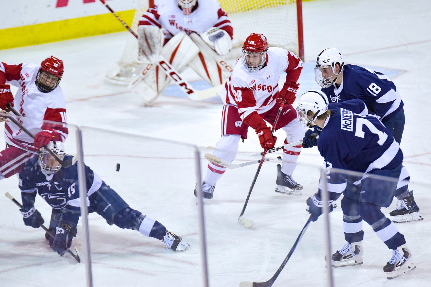 A faceoff is taken in the Badgers' defensive zone, as the centers fall to the ice following the draw. Aiden Dubinsky turns his eyes to the puck as two Penn State men's hockey players, including Gavin McKenna, do the same. A faceoff is taken in the Badgers' defensive zone, as the centers fall to the ice following the draw. Aiden Dubinsky turns his eyes to the puck as two Penn State men's hockey players, including Gavin McKenna, do the same.