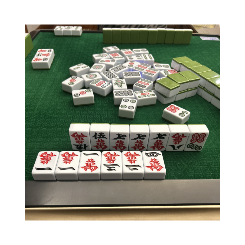 various mahjong tiles strewn across an automated mahjong machine table
