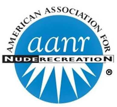 A blue circular logo with the words âAmerican Association for Nude Recreationâ in black around the edge and stylized white rays extending downward from the center. A blue circular logo with the words âAmerican Association for Nude Recreationâ in black around the edge and stylized white rays extending downward from the center.