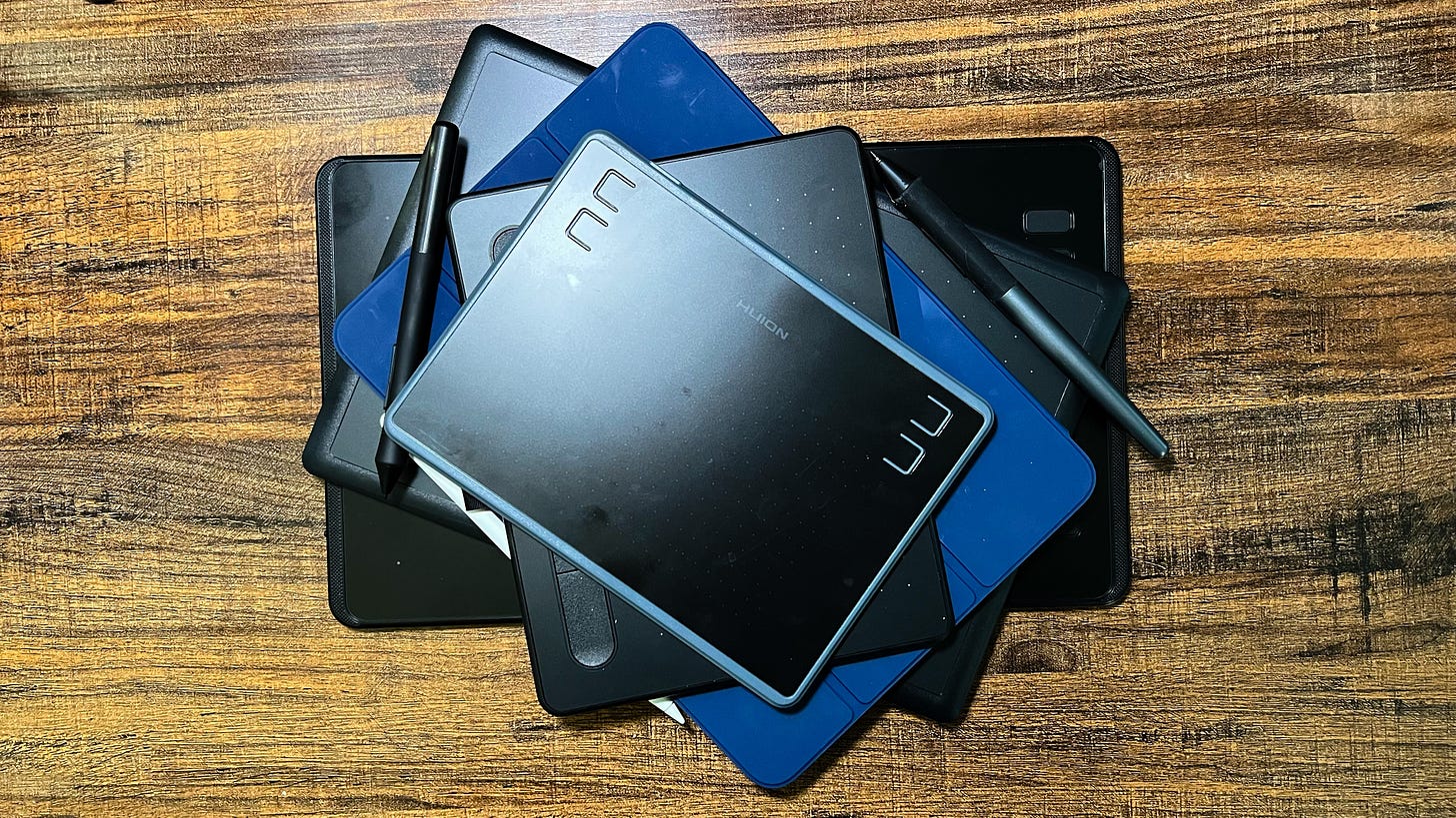 A pile of drawing tablets on a desk A pile of drawing tablets on a desk