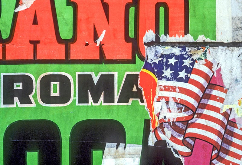 photo of torn circus poster showing Roma and American flag under