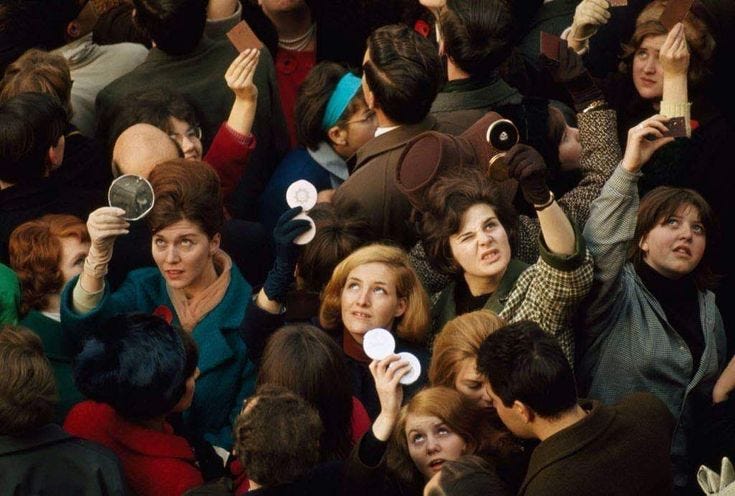 A crowd of women in 1960s London hold up compact mirrors to catch a glimpse of Queen Elizabeth II during a public appearance. The scene captures a collective act of ingenuity and anticipation, reflecting themes of perception and the lengths people go to engage with public figures. A crowd of women in 1960s London hold up compact mirrors to catch a glimpse of Queen Elizabeth II during a public appearance. The scene captures a collective act of ingenuity and anticipation, reflecting themes of perception and the lengths people go to engage with public figures.