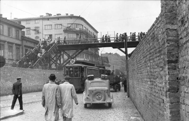 Photo of a footbridge connecting two walled off Jewish living areas in the Warsaw Ghetto, German occupied Poland, June 1942 Photo of a footbridge connecting two walled off Jewish living areas in the Warsaw Ghetto, German occupied Poland, June 1942