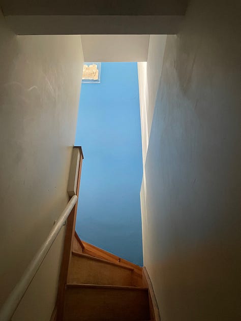 blue sky; grey clouds; blue wall on the way upstairs from my workshop