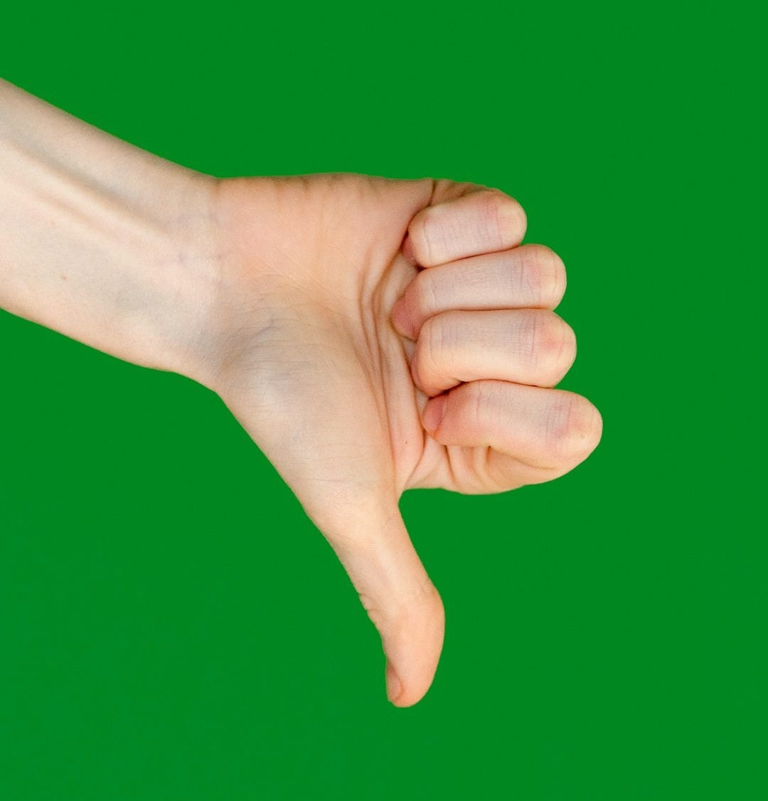 a person's hand holding a cell phone in front of a green background a person's hand holding a cell phone in front of a green background