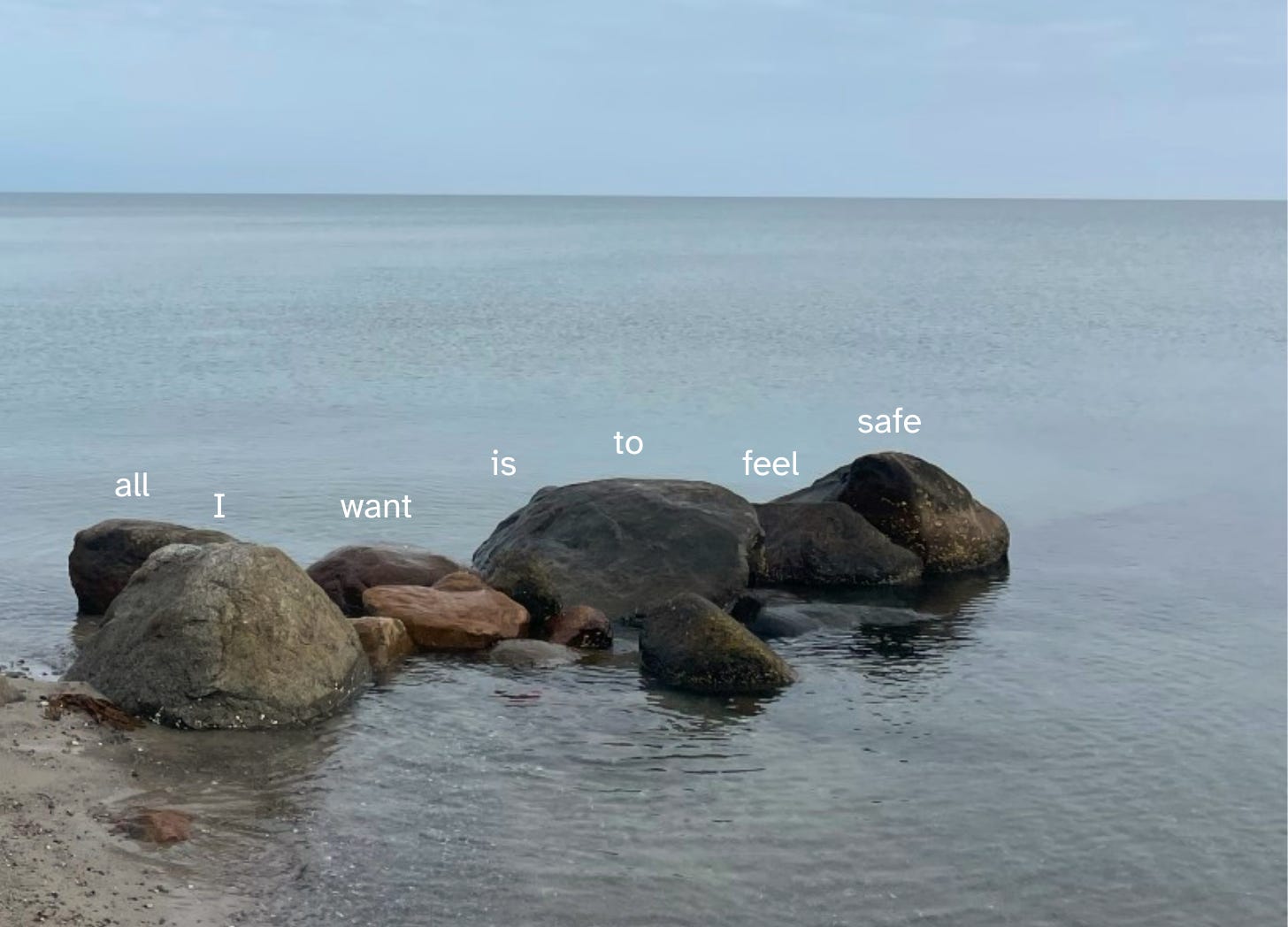 Stone jutting out into the ocean. Over the stones says, All I want is to feel safe
