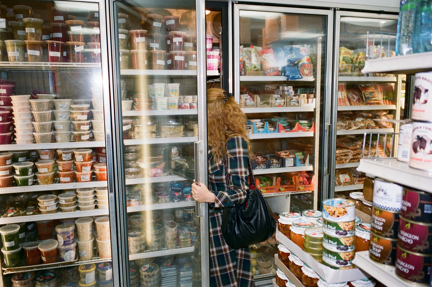 Vanessa opens the fridge at Odessa Grocery Vanessa opens the fridge at Odessa Grocery