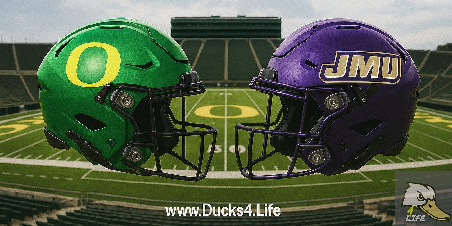 Oregon’s green “O” helmet and James Madison’s purple “JMU” helmet face each other at midfield in Autzen Stadium, with the Oregon “O” logo visible on the turf. Deals on seats, fan gear, and premium Oregon Football coverage at www.Ducks4.Life