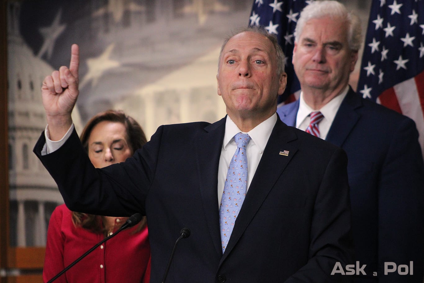 A politician in a suit raises his finger while answering reeporters' questions in US Capitol Photo: Logan Johnson for © www.askapolpolitics.com