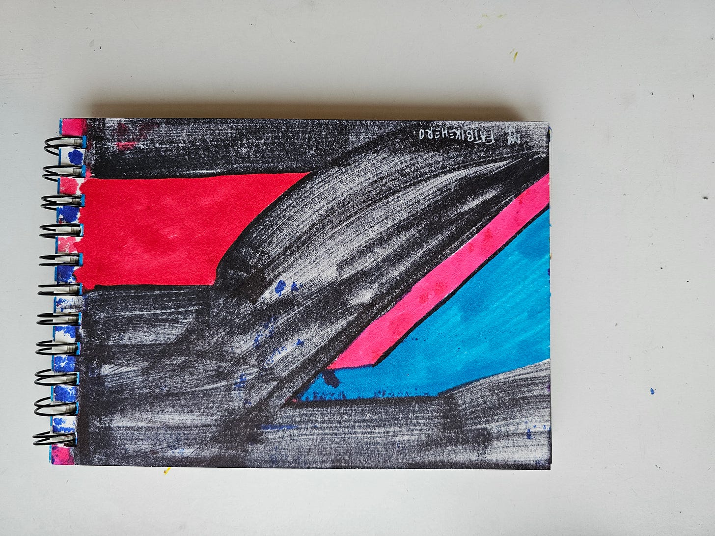 A horizontal abstract sketchbook drawing by FatbikeHero titled "The A.I Vassal." The image features aggressive black marker strokes creating a diagonal motion, juxtaposed against a bold red rectangular block, a cyan blue triangle, and a diagonal hot pink stripe. The style is raw, expressive, and reminiscent of a deconstructed flag. A horizontal abstract sketchbook drawing by FatbikeHero titled "The A.I Vassal." The image features aggressive black marker strokes creating a diagonal motion, juxtaposed against a bold red rectangular block, a cyan blue triangle, and a diagonal hot pink stripe. The style is raw, expressive, and reminiscent of a deconstructed flag.