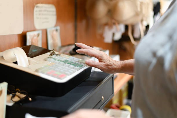 Close up of old woman hand on the cash register, Female hand on the cash register in a store. Close up of old woman hand on the cash register, Female hand on the cash register in a store. Sales Tax at register stock pictures, royalty-free photos & images