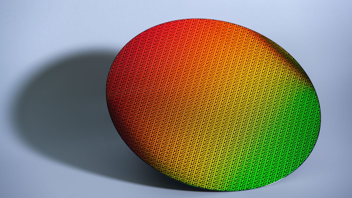 Intel 18A wafer with a long shadow on a light blue background