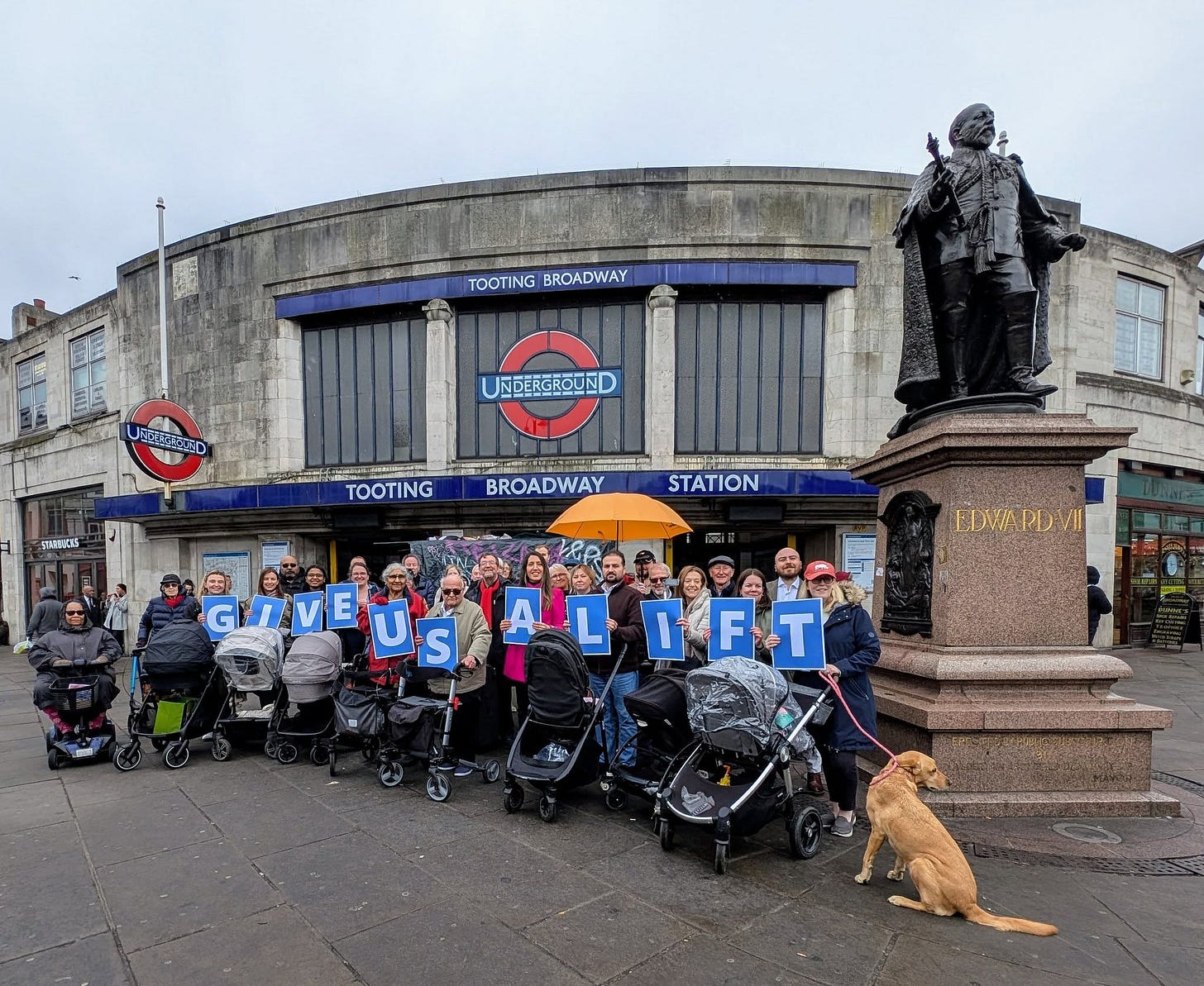 May be an image of 4 people, street, crowd and text May be an image of 4 people, street, crowd and text