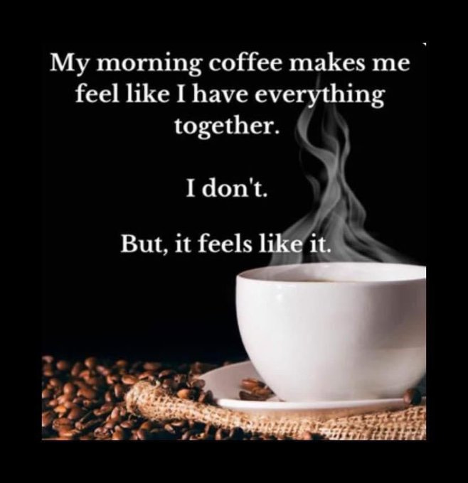 A white ceramic coffee cup with steam rising from it, placed on a saucer. Coffee beans are scattered on a burlap surface beneath the cup.