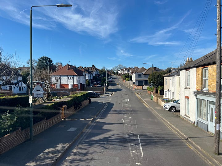 Photo showing narrow streets and following another non-express bus.