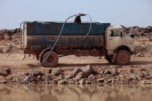 A man pumps water into a tanker in northeastern Jordan. (Image credit: Getty Images)