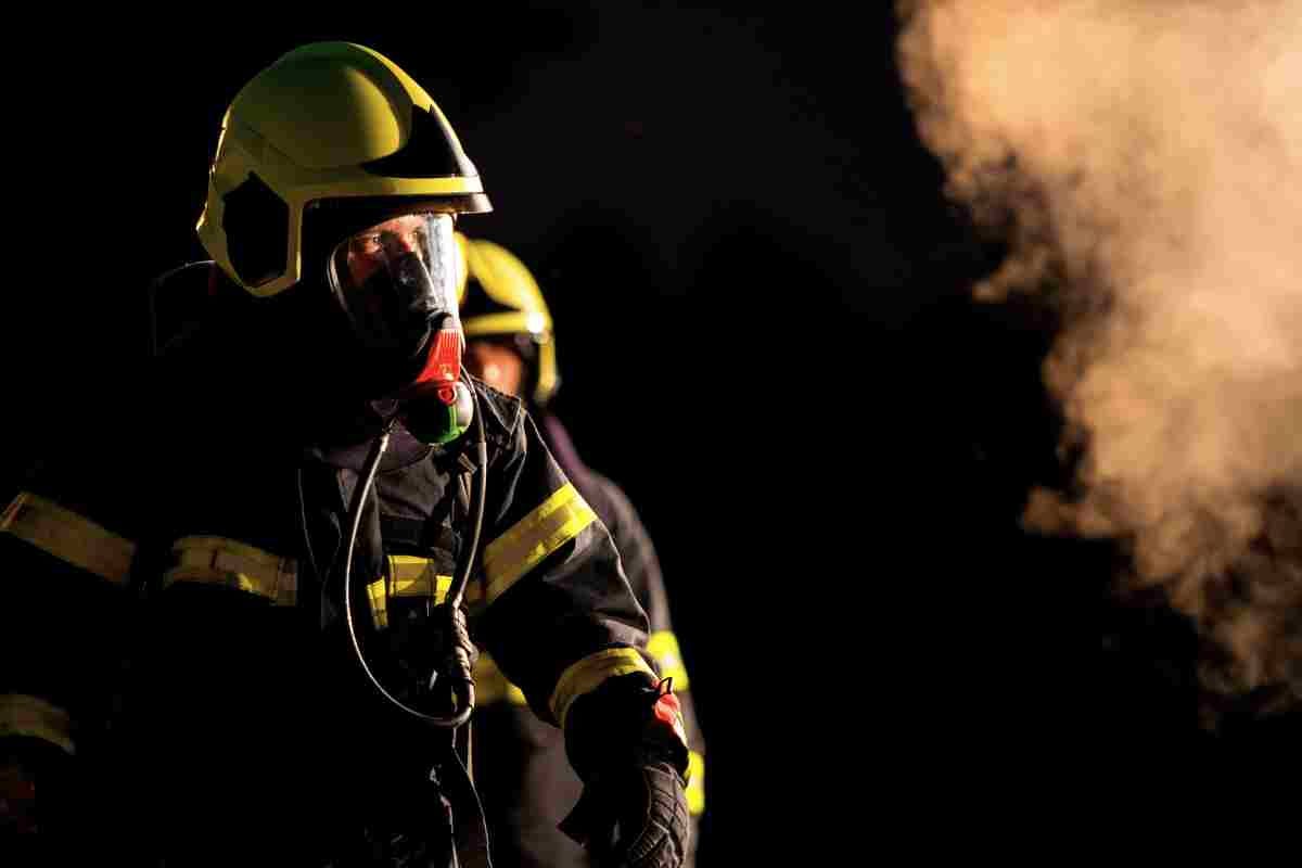 Firefighters moving through smoke and darkness during an emergency response