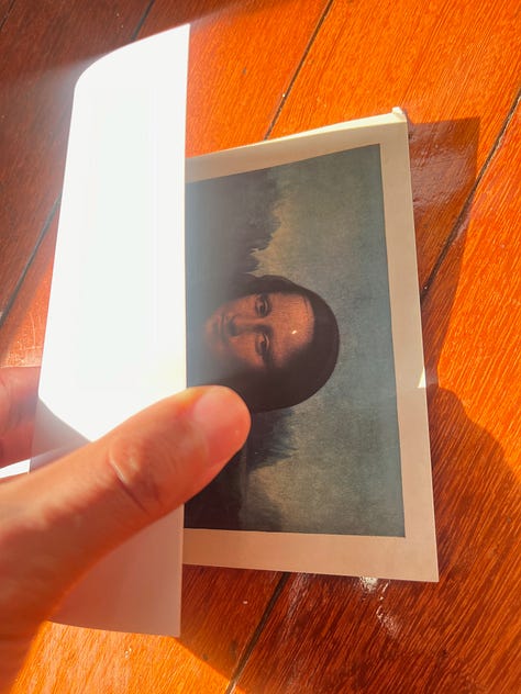 1. Juan takes a self portrait with analog camera wearing a house robe and a magen david gold necklace. 2. A bird frozen in time against the golden rays of sun. 3. A screen capture of two figures screaming "Tashlich" on top of the High Line. 4. A folded postcard of the mona lisa during the 2024 solar eclipse. 5. A rabbi answering the question G-d, "I picture love, justice, truth, and beauty. 6. A rendering of a figure stepping on a pink circular form. 7. A back-and-image of a shirt dangling from a tree. 8. A green landscape in Colombia, it seems like it had rained or was just about to rain. 9. A hand holding a necklace with two rings above a vase of drying sunflowers in black-and-white.