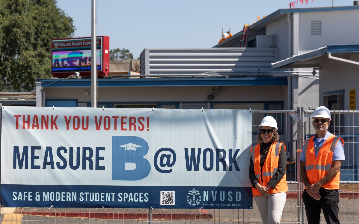A person in a safety vest standing in front of a sign

AI-generated content may be incorrect.
