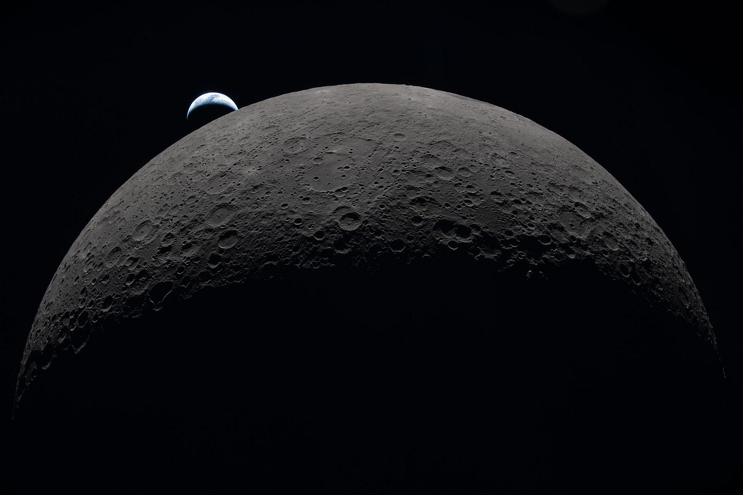 A photo taken during the Artemis II mission around the Moon, showing the Earth setting beyond