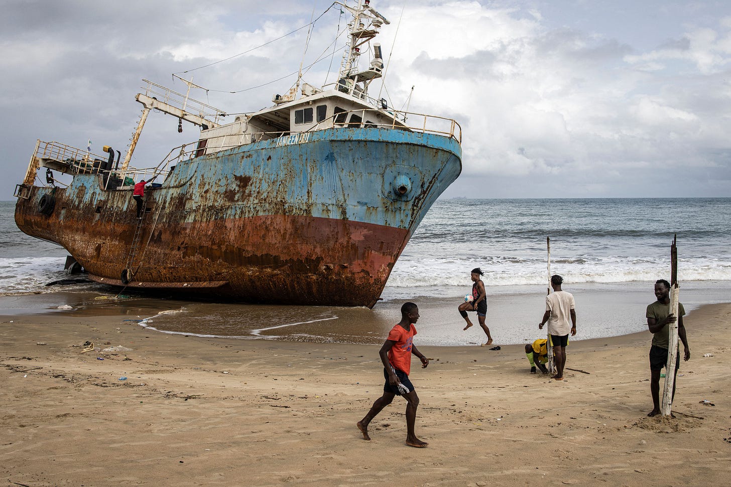 Football players set up goal posts along Lumley beach in Freetown on June 25, 2023, the day after Sierra Leone's general and presidential elections. (Photo by John Wessels/AFP via Getty Images)
