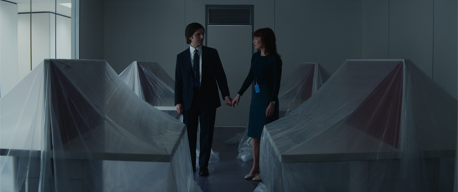Mark and Helly holding hands in an empty office on the severed floor