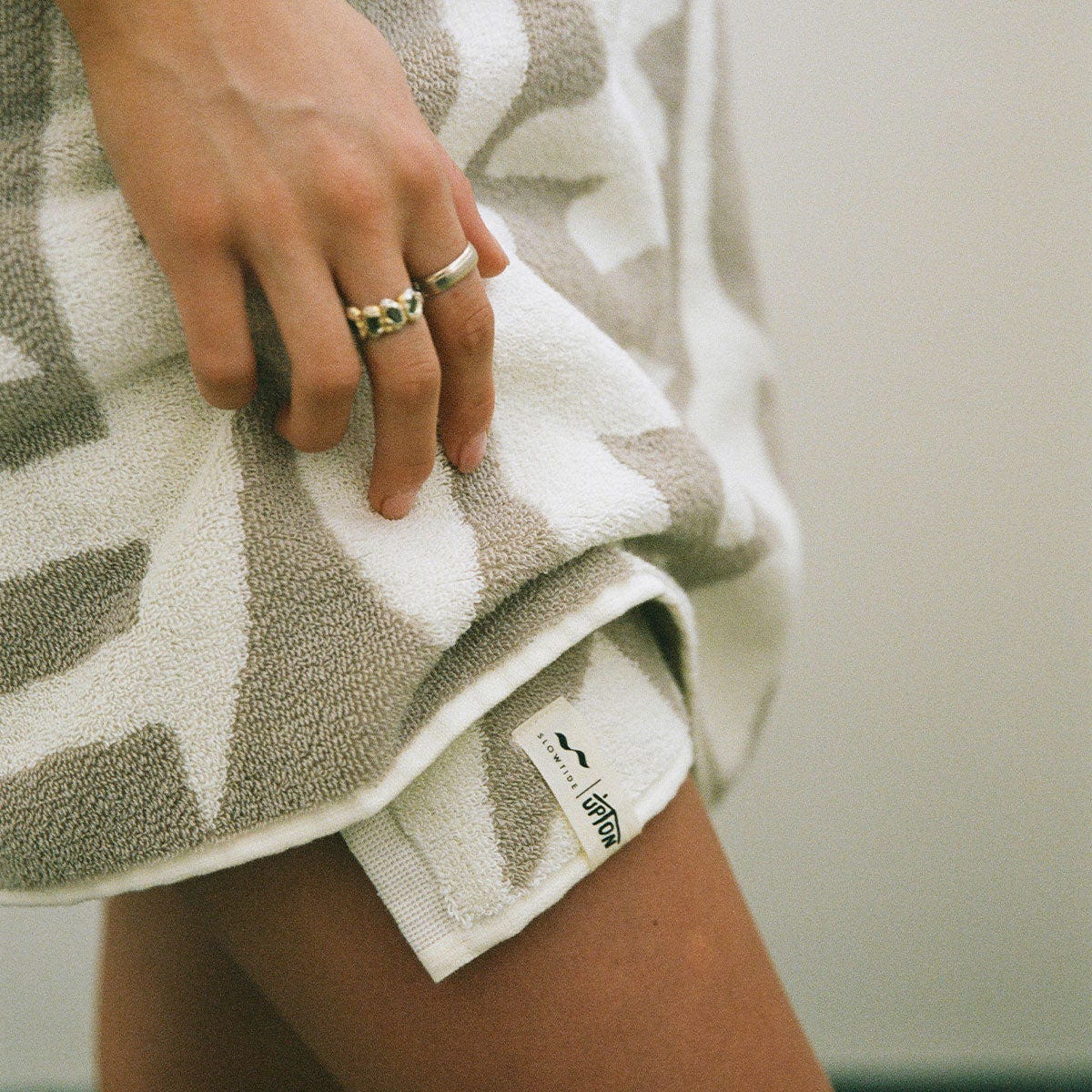 Bath and hand towel bundle with geometric pattern and fabric tag.