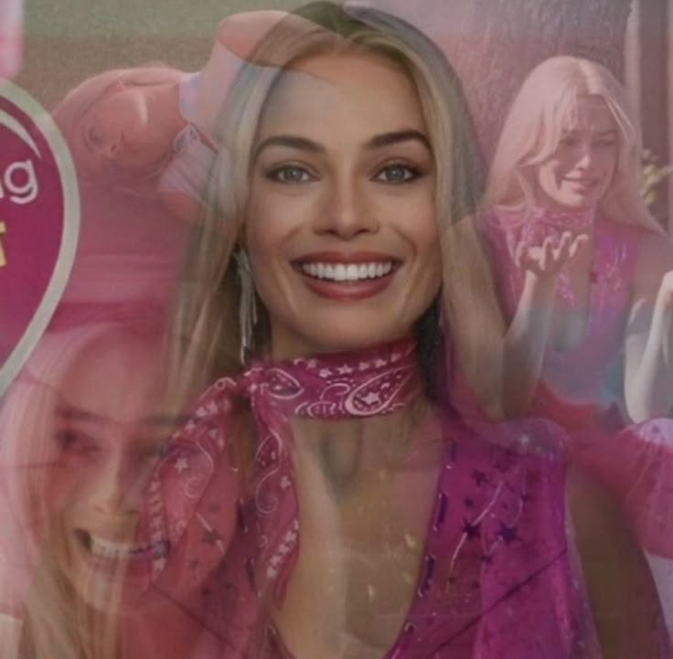 This may contain: a woman with blonde hair and pink dress smiling This may contain: a woman with blonde hair and pink dress smiling