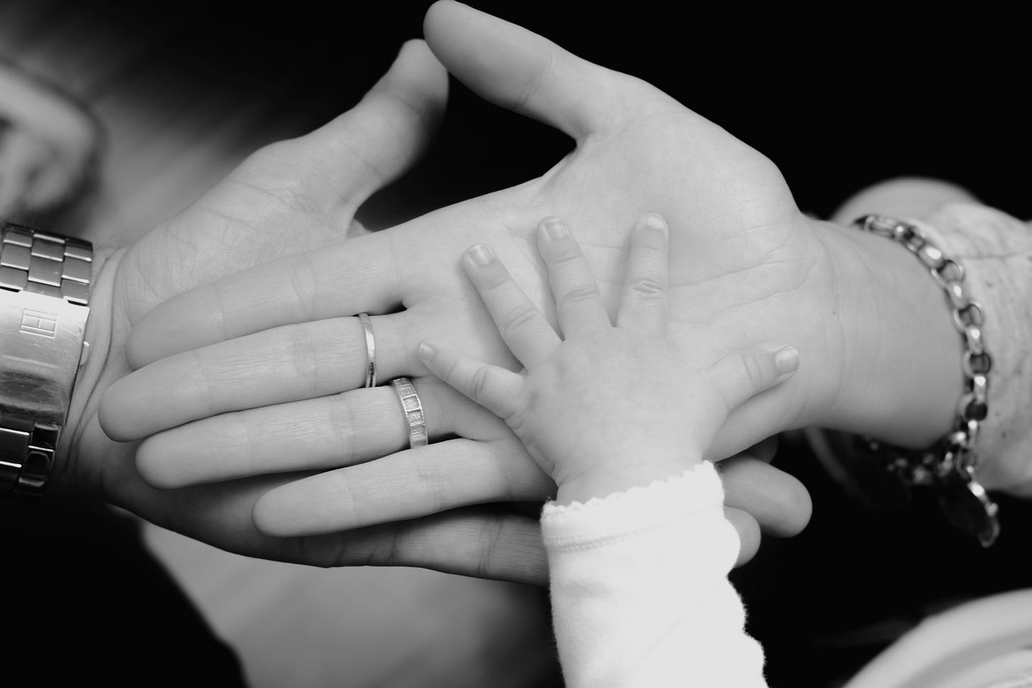 Husband wife baby hands