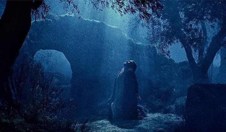 This may contain: a man standing in the middle of a forest at night with his head turned to the side