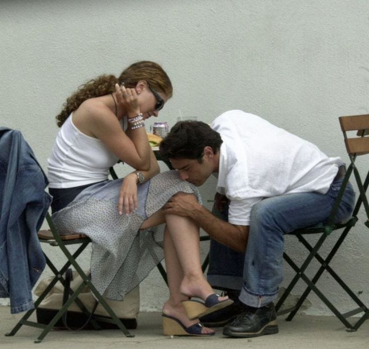 This may contain: a man and woman sitting on chairs next to each other
