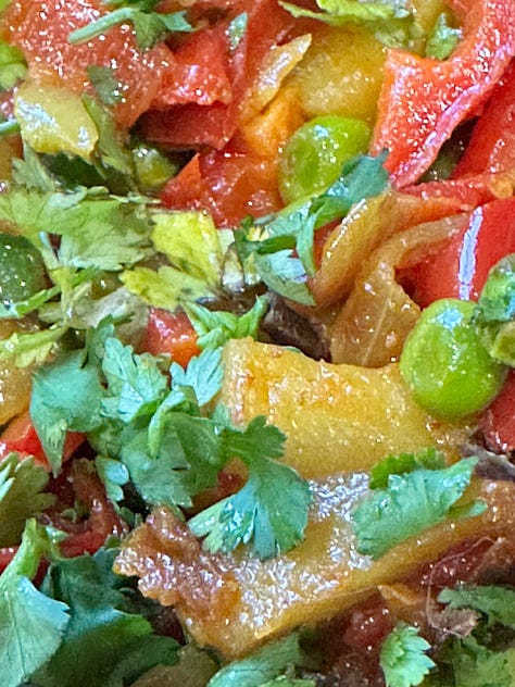 multicolored vegetables - cilantro, potatoes, bell peppers, peas, green beans