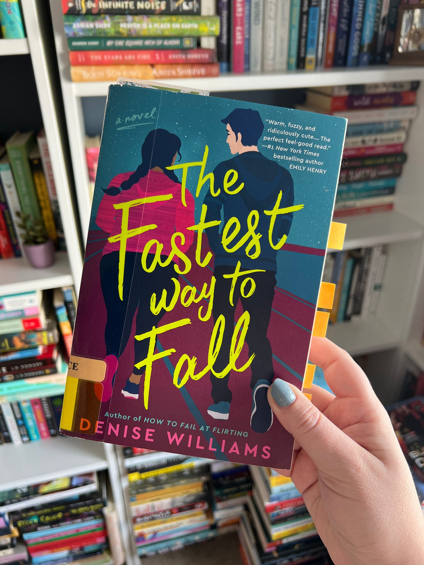 My hand holding the book The Fastest Way to Fall.