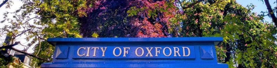 A blue sign with yellow text and trees in the background
AI-generated content may be incorrect. A blue sign with yellow text and trees in the background
AI-generated content may be incorrect.
