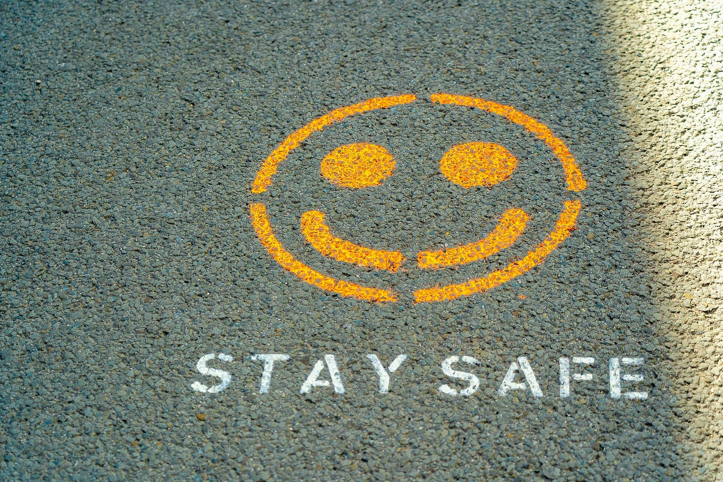 picture of a smiling emoji with stay safe written below.