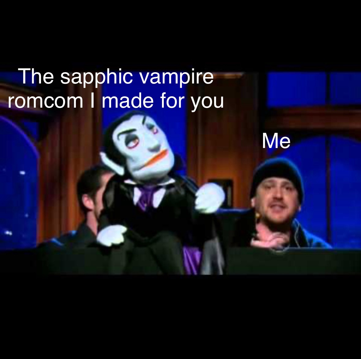 This is Jason Segal in a beanie and awkward smile holding up a vampire puppet he made for a Dracula musical while in a state of aimless depression