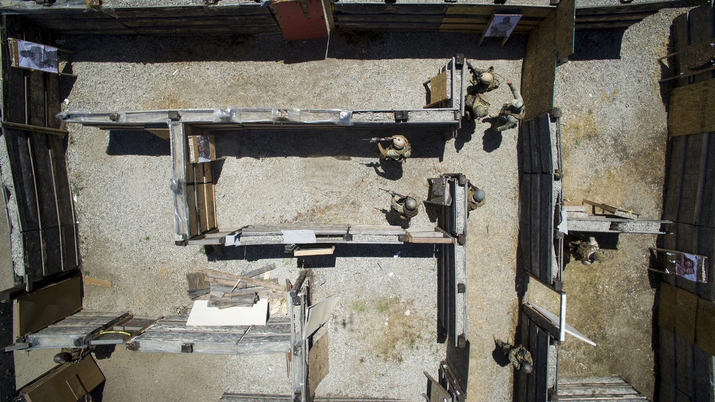 Combat cameramen from the Navy, Marine Corps, and Air Force perform live-fire close quarter battle drills during the 2016 Summer Quick Shot Exercise in Azusa, California, May 18, 2016. Quick shot is a biannual Fleet Combat Camera Pacific exercise that provides live-fire and scenario based training to combine-joint combat camera assets. (U.S. Navy Combat Camera photo by Mass Communication Specialist 1st Class John Callahan/Released) 