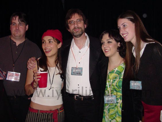 Five people standing at a party Five people standing at a party