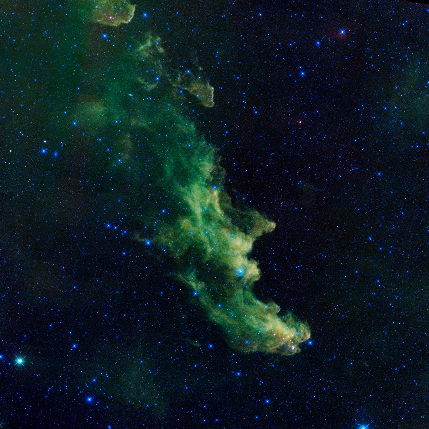 A color photo of a green-tinted nebula A color photo of a green-tinted nebula
