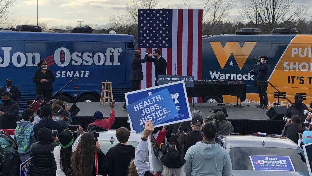 Warnock, Ossoff appeal to young voters at hip-hop focused DeKalb rally