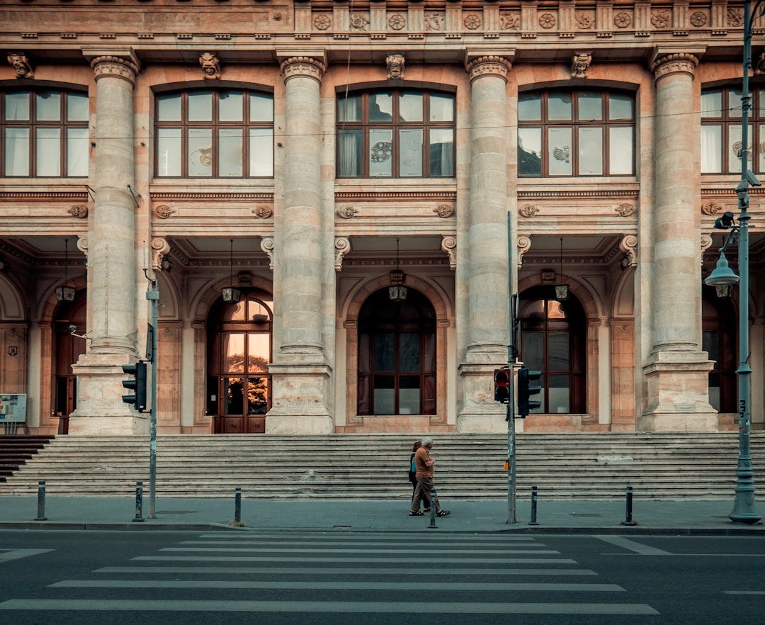 person walking pass building person walking pass building