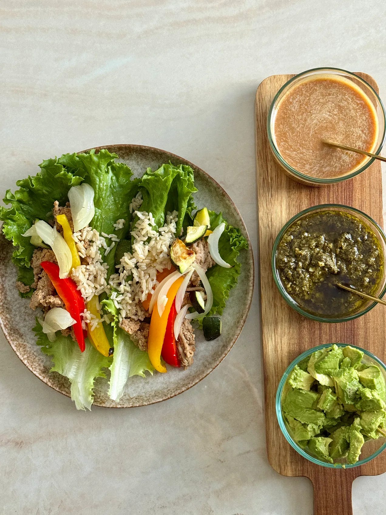 turkey pesto lettuce wraps with peanut sauce, pesto, and avocado