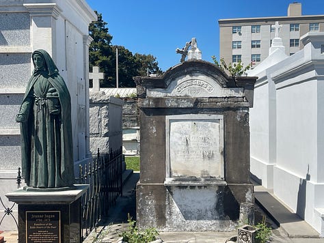 Images of New Orleans' French Quarter + swamp, including iconic balconies dripping in ferns, a swamp gator near Slidell, Jordan in front of blue doors, a cemetary and two tarot card spreads.