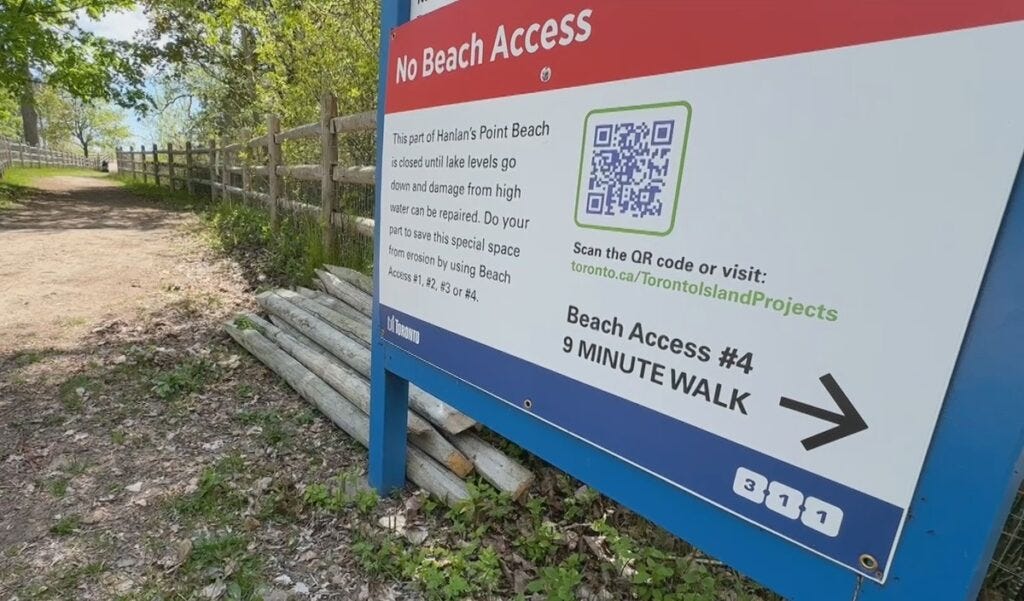 A City of Toronto sign warns that part of Hanlan's Point Beach is closed due to shoreline erosion.