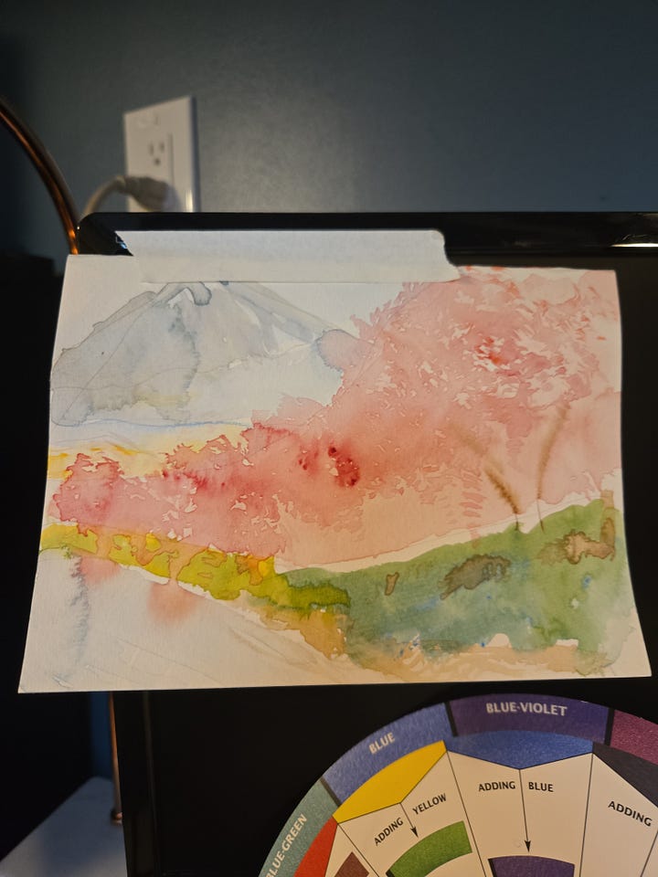 Watercolor sketchbook spread of Mount Fuji and cherry blossoms, paired with Japanese calligraphy and practice sketches inspired by Japan.