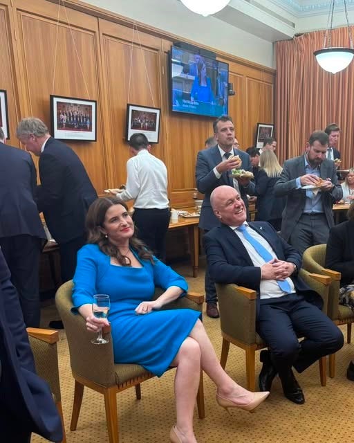 National MPs eating and drinking and looking cheerful in the parliamentary rooms