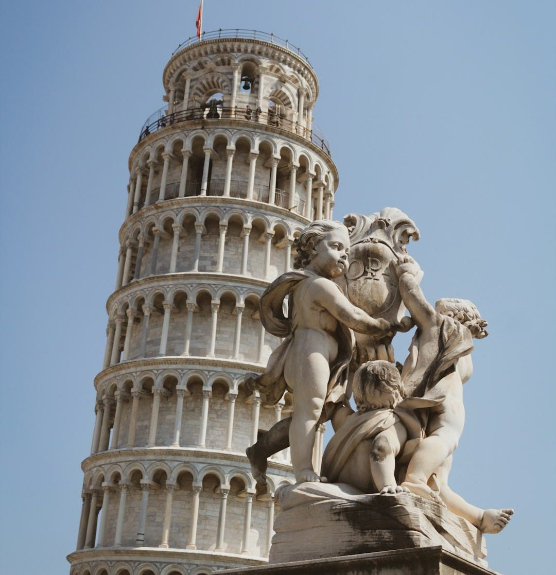 a tall tower with a statue on top of it