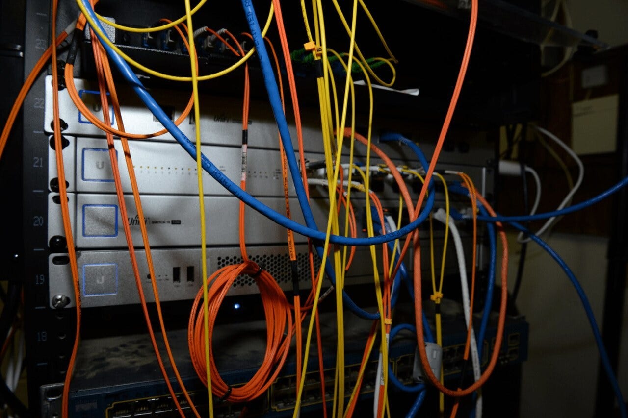 A server rack filled with colorful cables and networking equipment. A server rack filled with colorful cables and networking equipment.