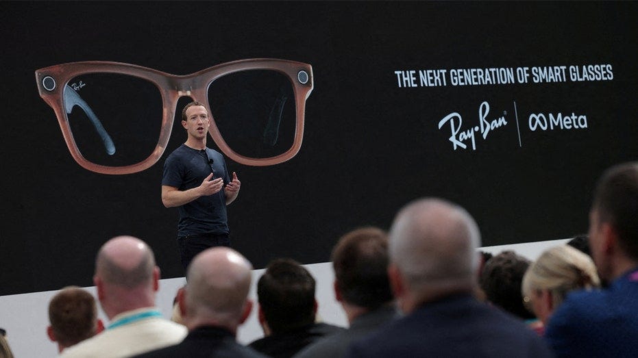 Mark Zuckerberg unveils new caramel-colored Ray-Ban Meta smart glasses in front of a crowd.